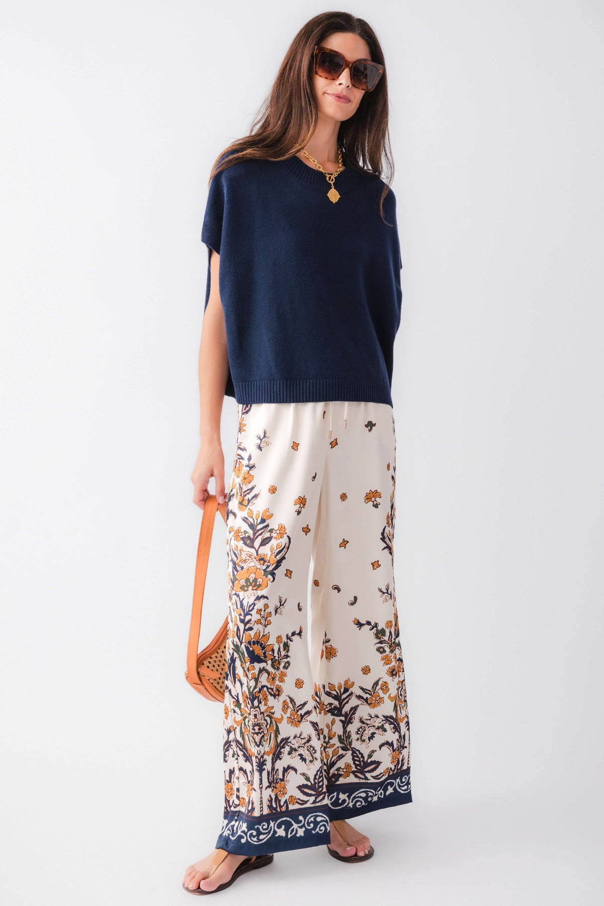 Ivory satin wide-leg pants, navy floral border along the cuffs