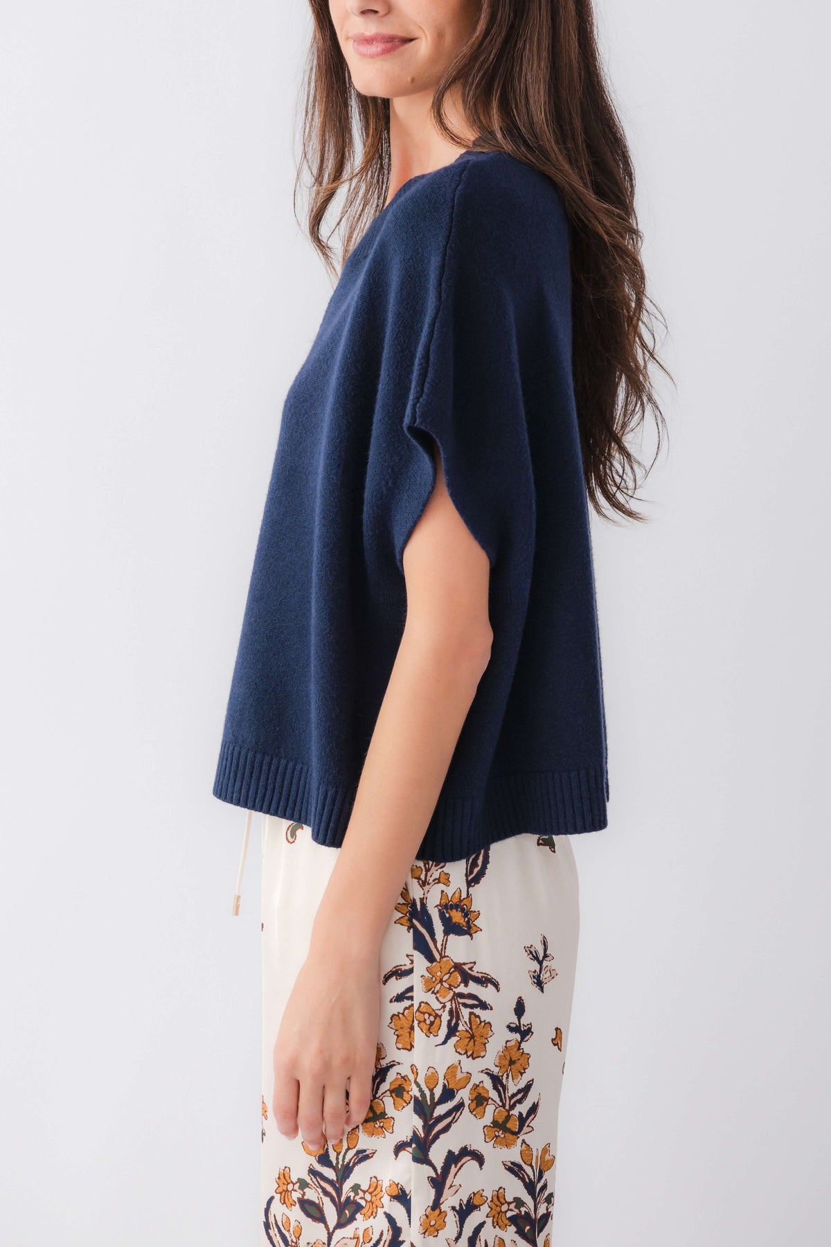 Ink blue dropped-shoulder knit top with loose short sleeves and ribbed bottom hem