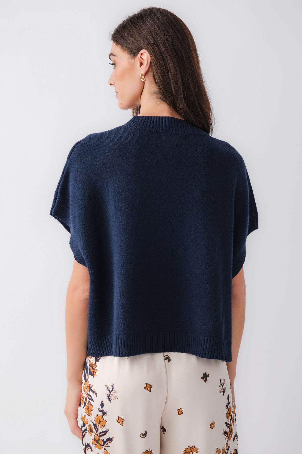 Ink blue dropped-shoulder knit top from back view with ribbed hem and neckline