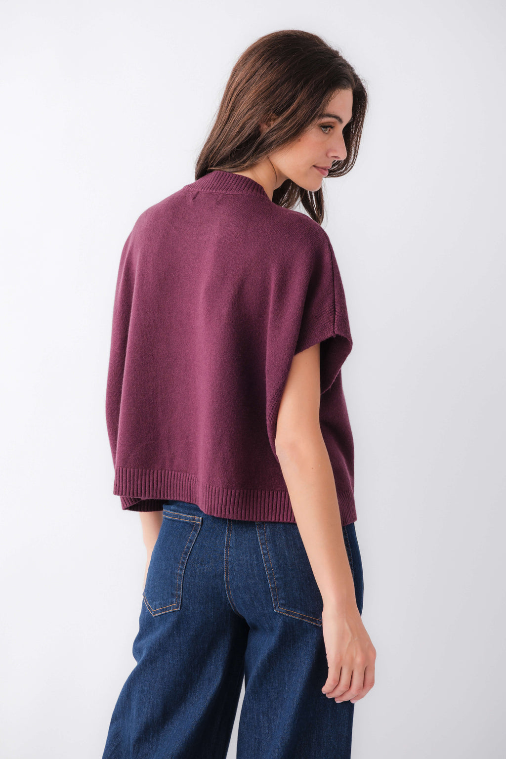 Burgundy dropped-shoulder knit top from back view with ribbed hem and neckline