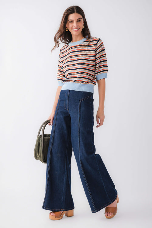 High-waisted dark denim flare pants with front patch pockets and wide flared hem