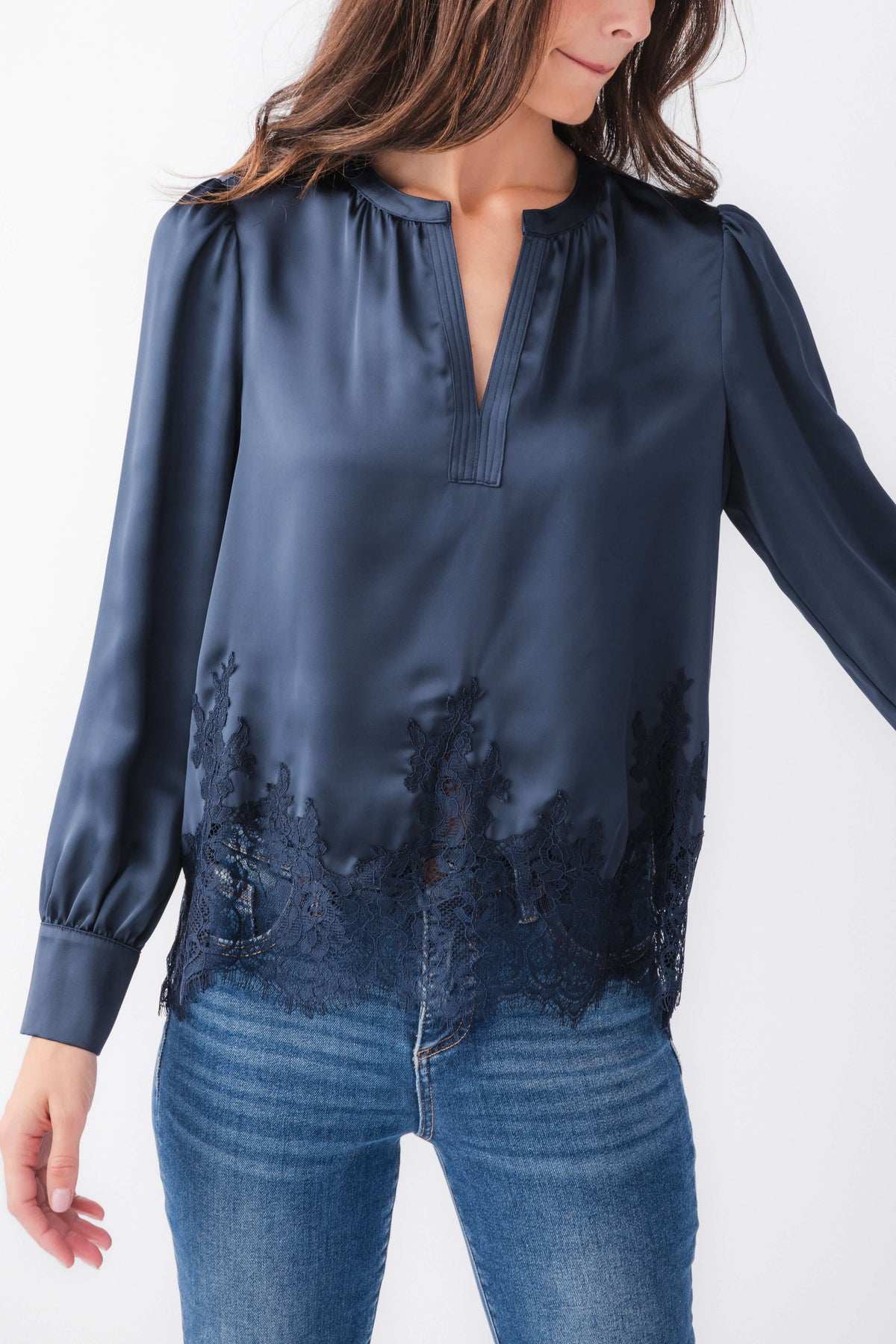 Navy splitneck satin top with lace hem panel and long puffed sleeves