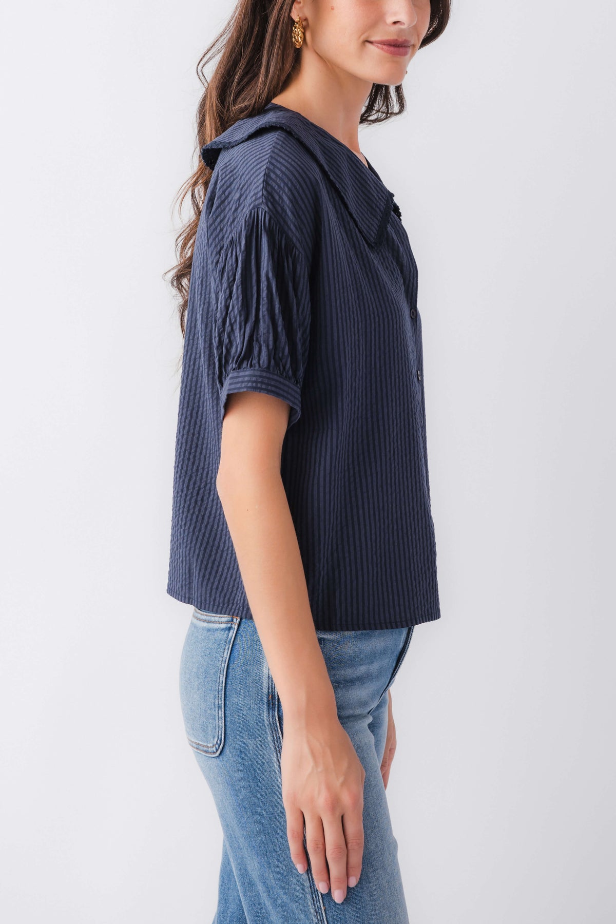 Midnight blue pinstripe short-sleeve top with peter pan collar, side view
