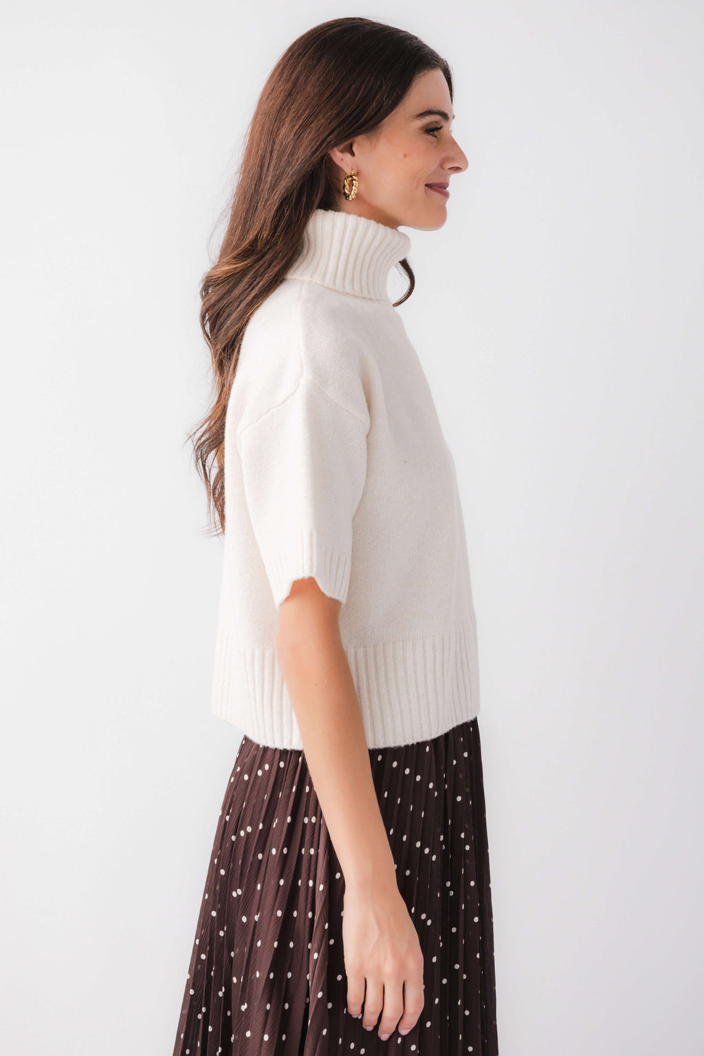 Off-white short-sleeve turtleneck knit sweater, side view, ribbed knit trim