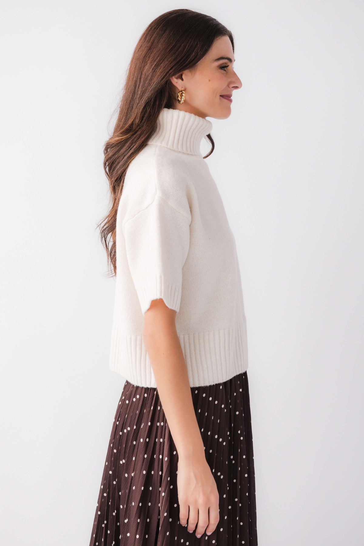 Off-white short-sleeve turtleneck knit sweater, side view, ribbed knit trim