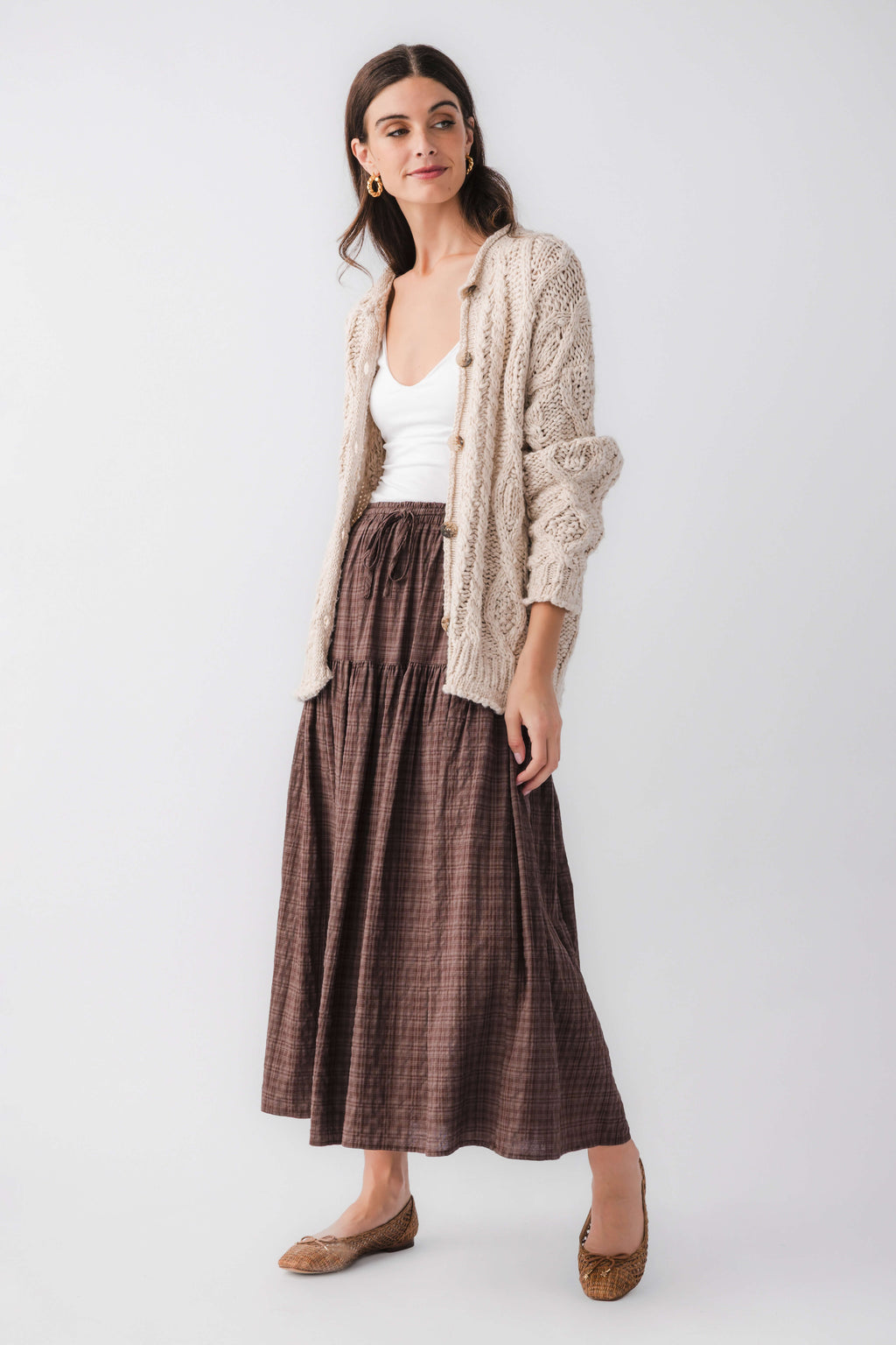 Cream cable-knit cardigan with button front and long sleeves