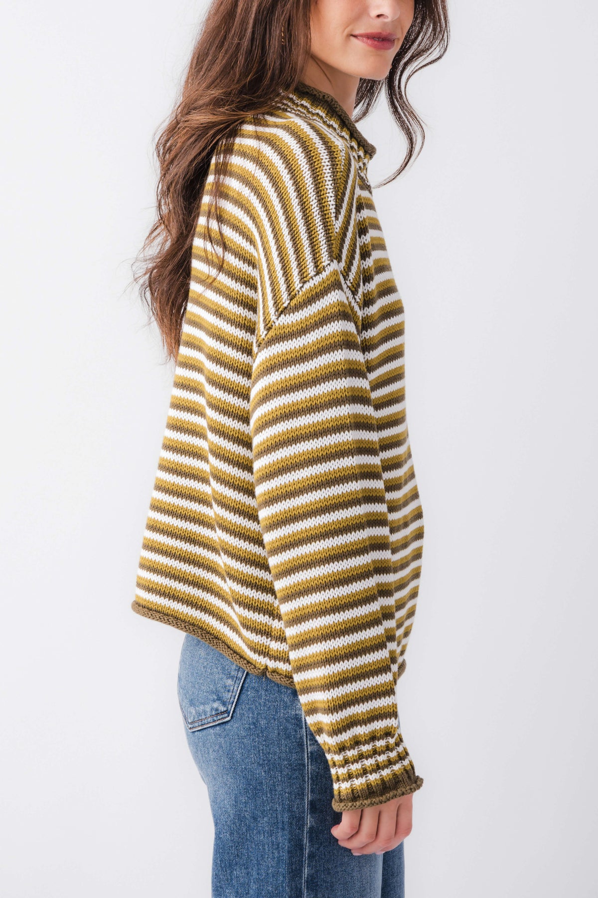Striped mockneck sweater with yellow-and-cream horizontal stripes and ribbed cuffs