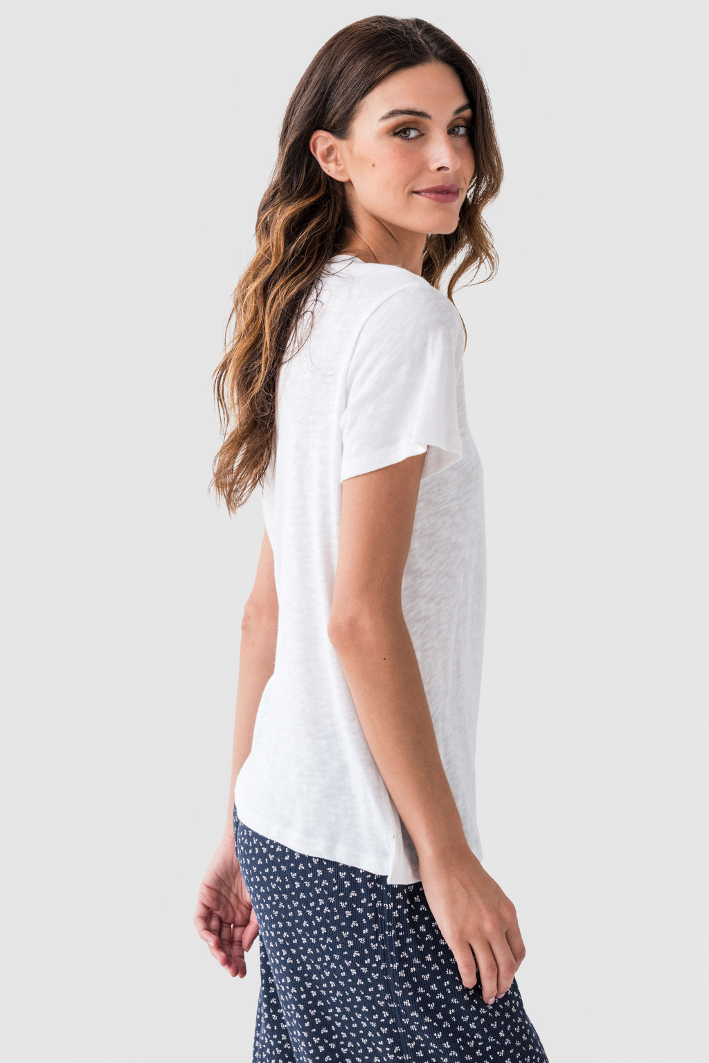 White slub tee shirt from the side with crew neck, short sleeves, and relaxed drape.