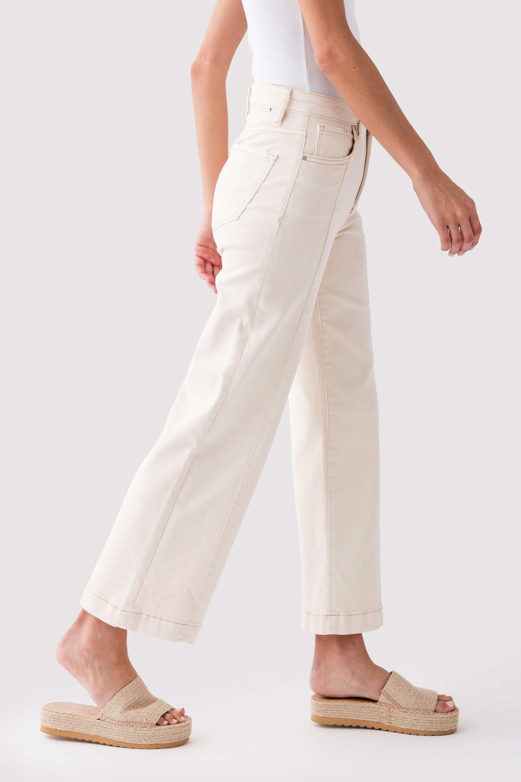 Ivory high-rise wide-leg ankle jeans with visible front seams and wide leg opening