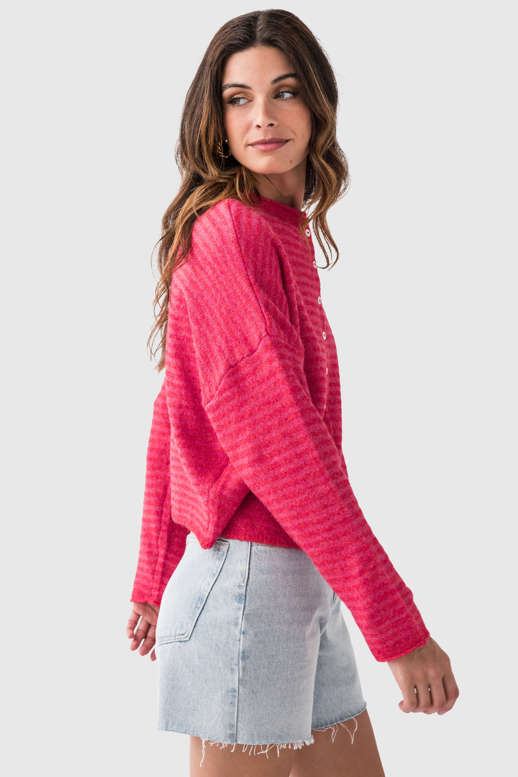 Cherry red striped cardigan with long sleeves and button front, side view
