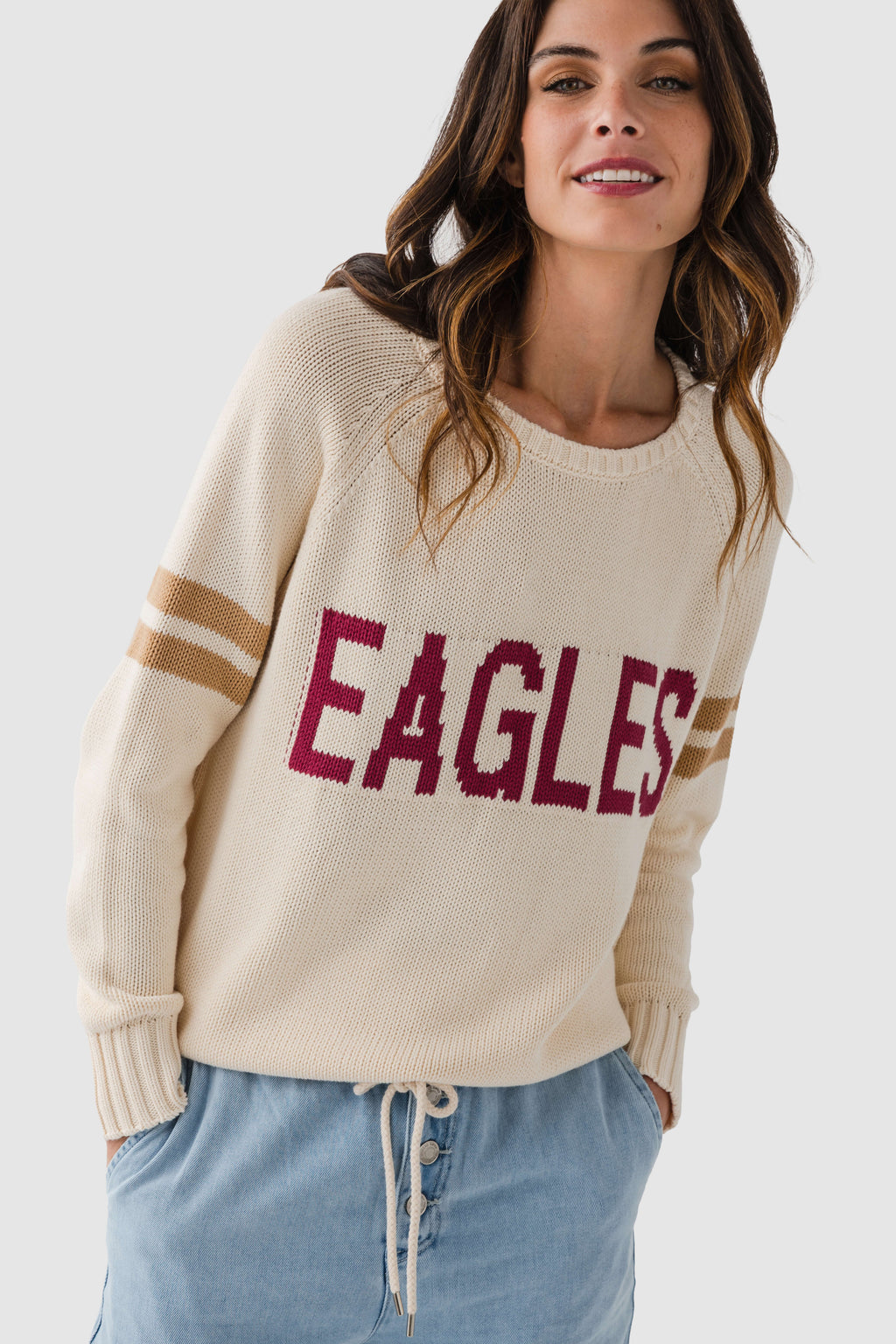 Cream knit sweater with maroon "EAGLES" logo and ribbed cuffs