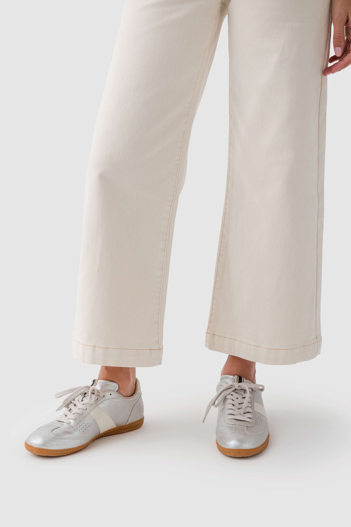 Shu Shop Sydney sneakers with white laces, light uppers, and tan rubber soles