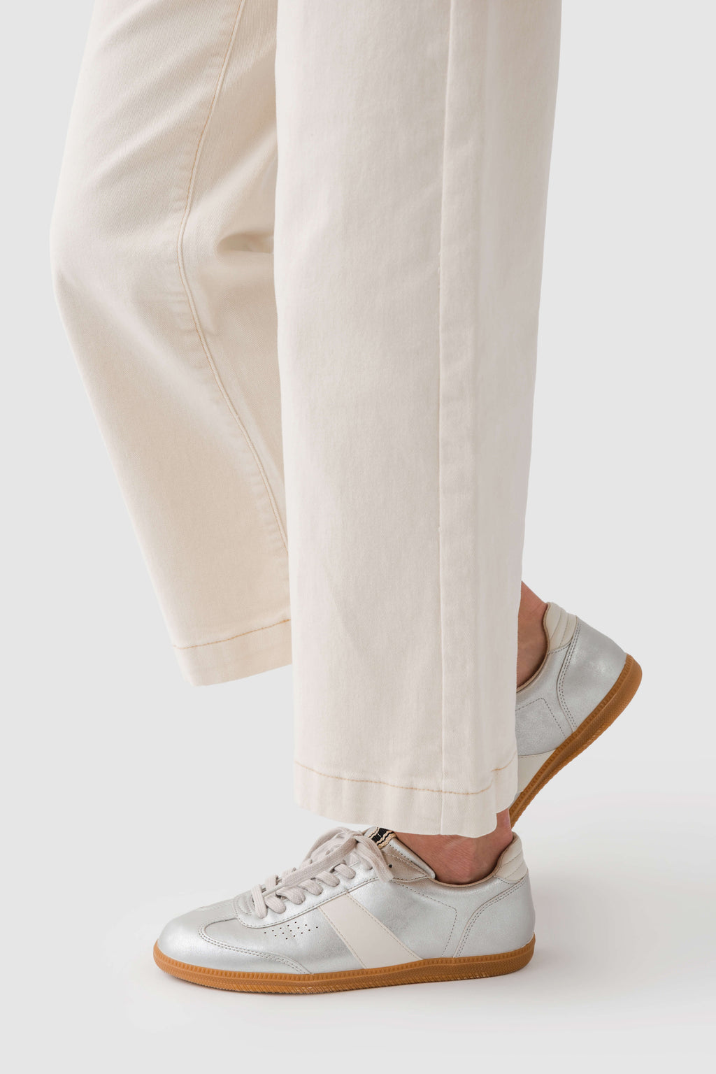 Shu Shop Sydney sneaker side view with white laces and tan outsole, light upper