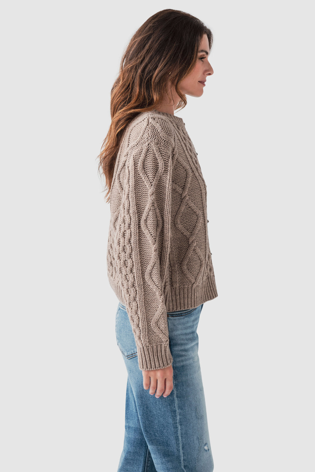 Taupe cable-knit sweater side view with diamond and cable textures, long sleeves