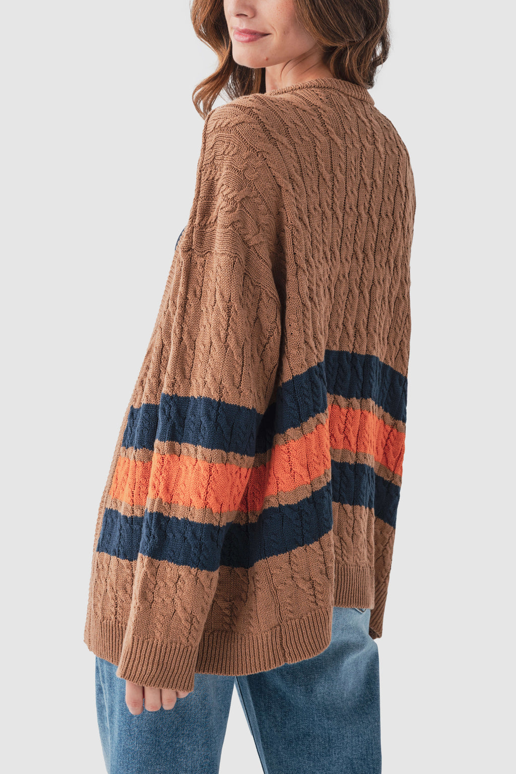 Back view of brown cable-knit varsity cardigan with navy and orange stripe bands