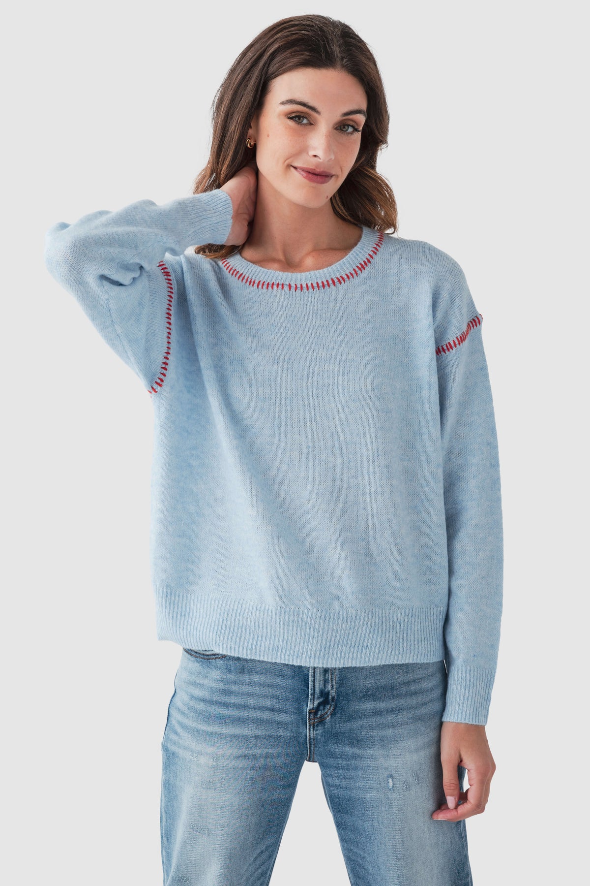 Light blue crewneck sweater with red contrast stitch detail at neckline and sleeves