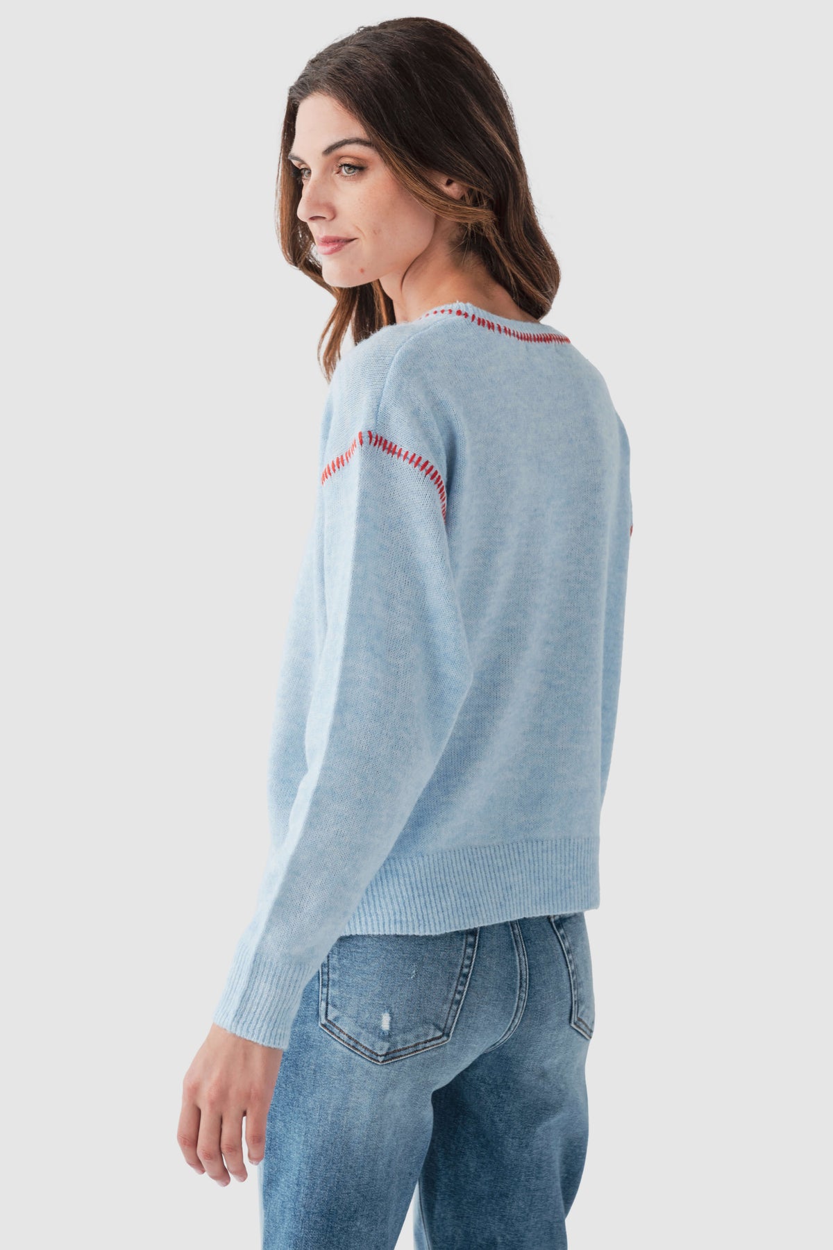 Light blue crewneck sweater with red contrast stitch, long sleeves, ribbed hem
