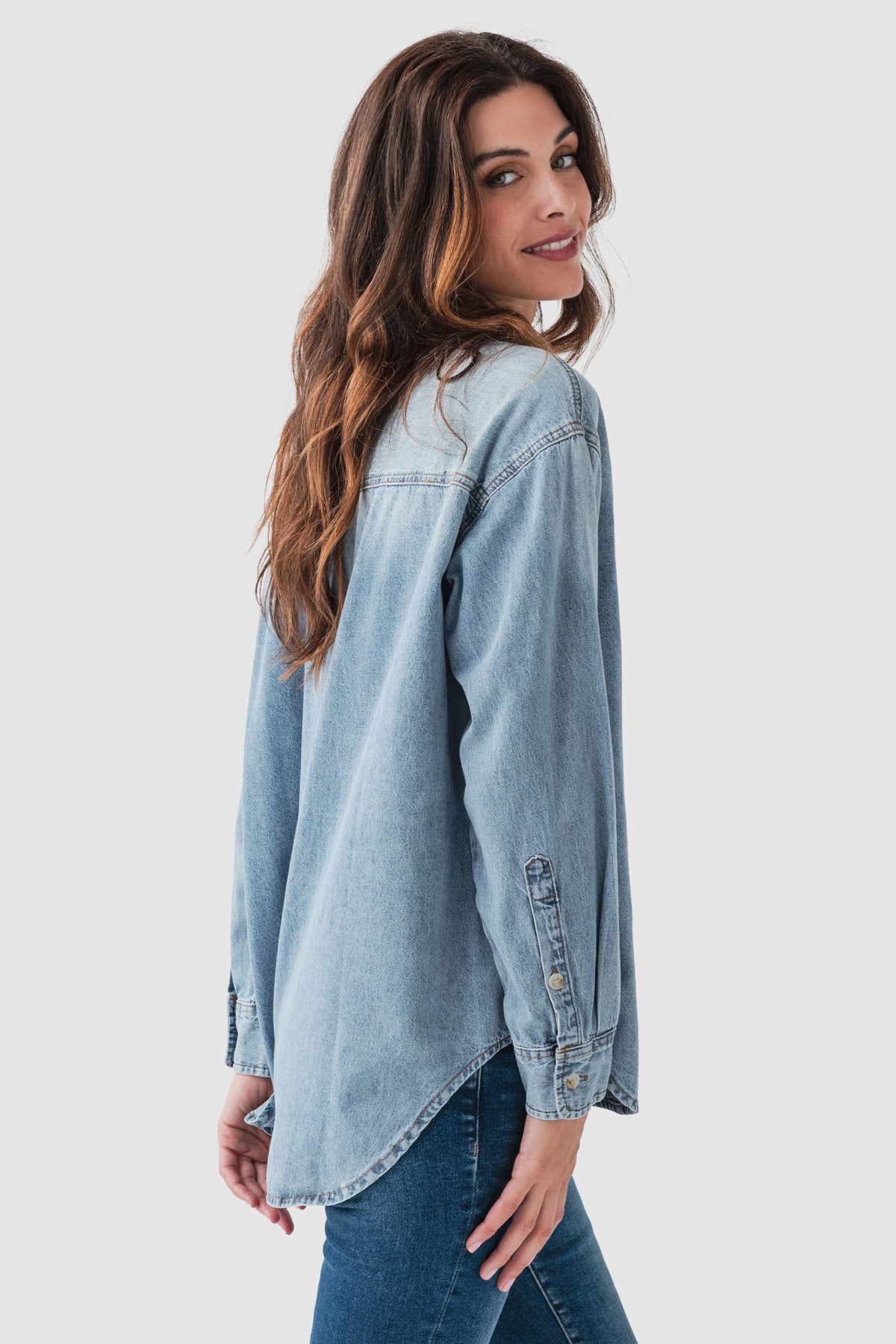 Blue denim button-up top with collar and long sleeves