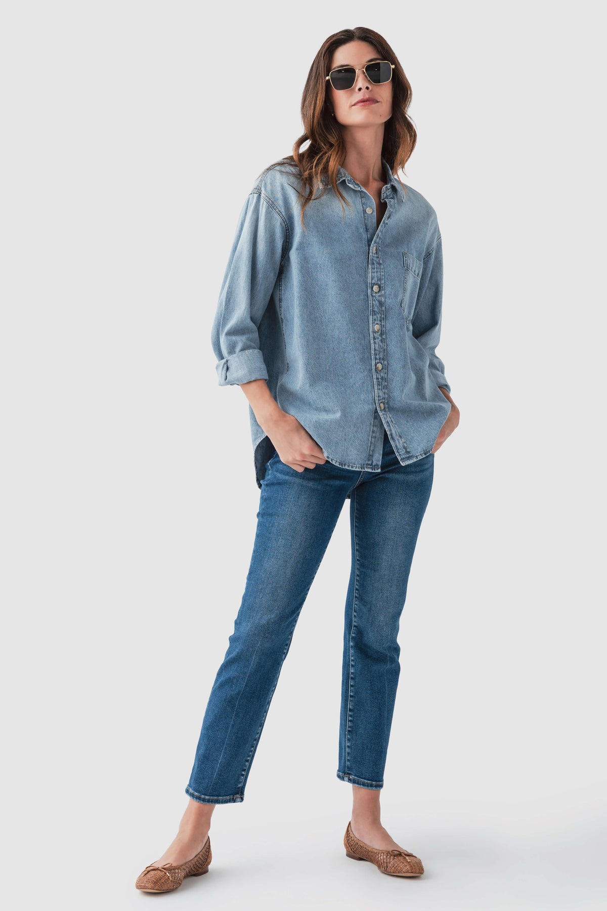 High-rise straight crop jeans on model, light blue wash with button front and seams