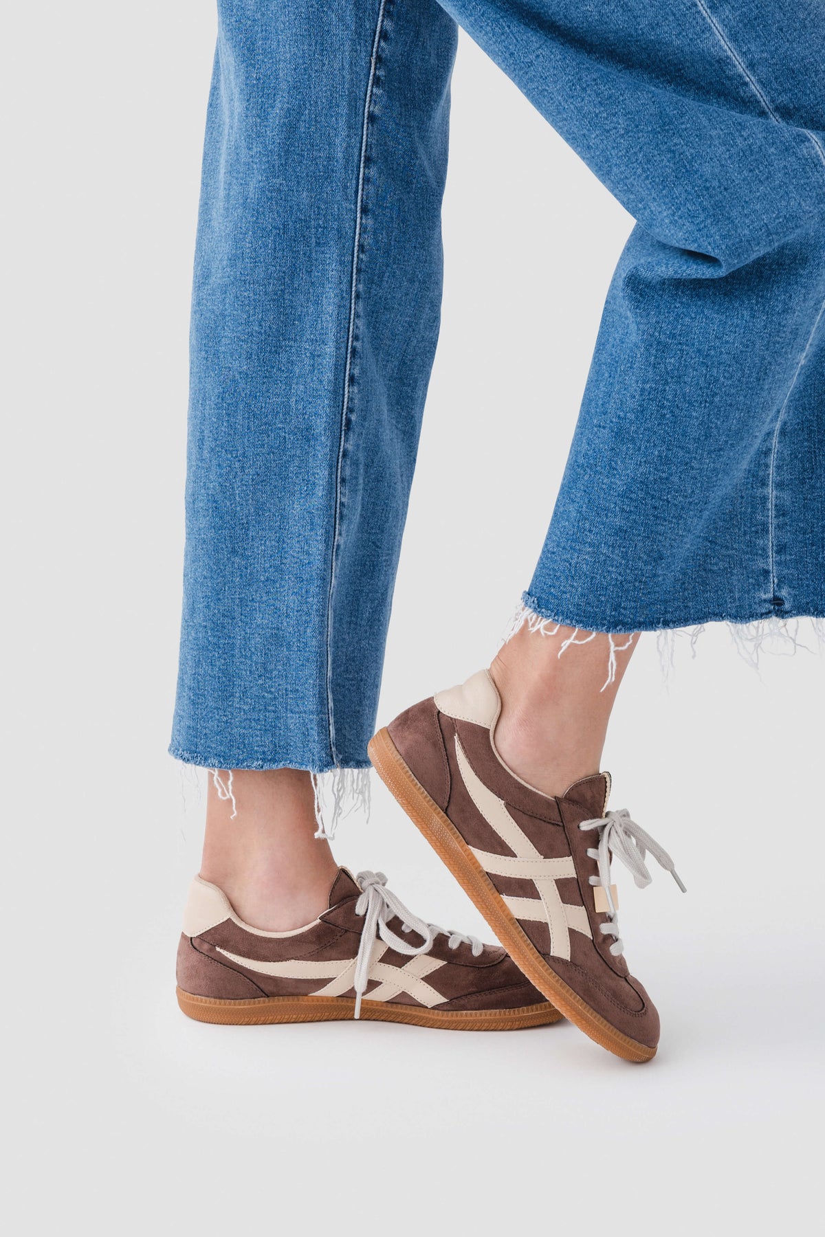 Brown suede lace-up sneaker with white laces and side stripe detail