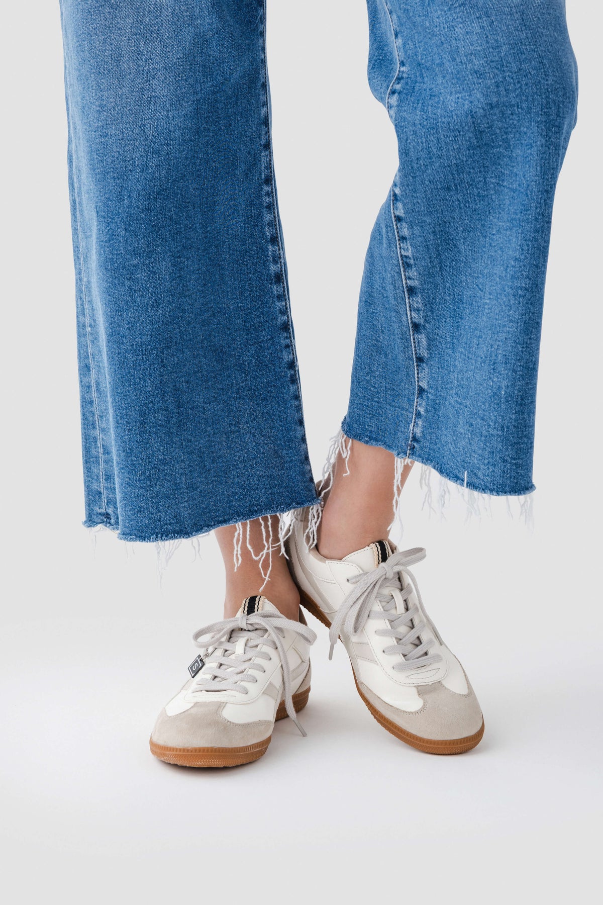 White lace-up sneaker with gum sole and low-profile design