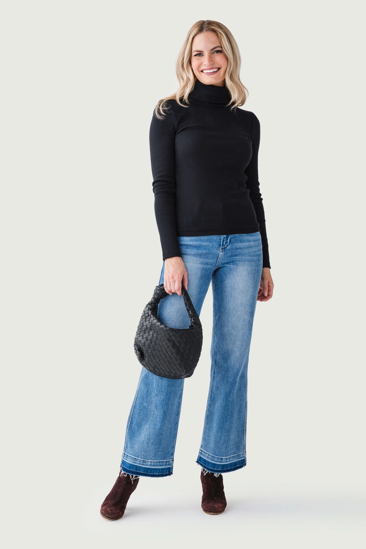 Black long-sleeve turtleneck top with high neck, slim fit