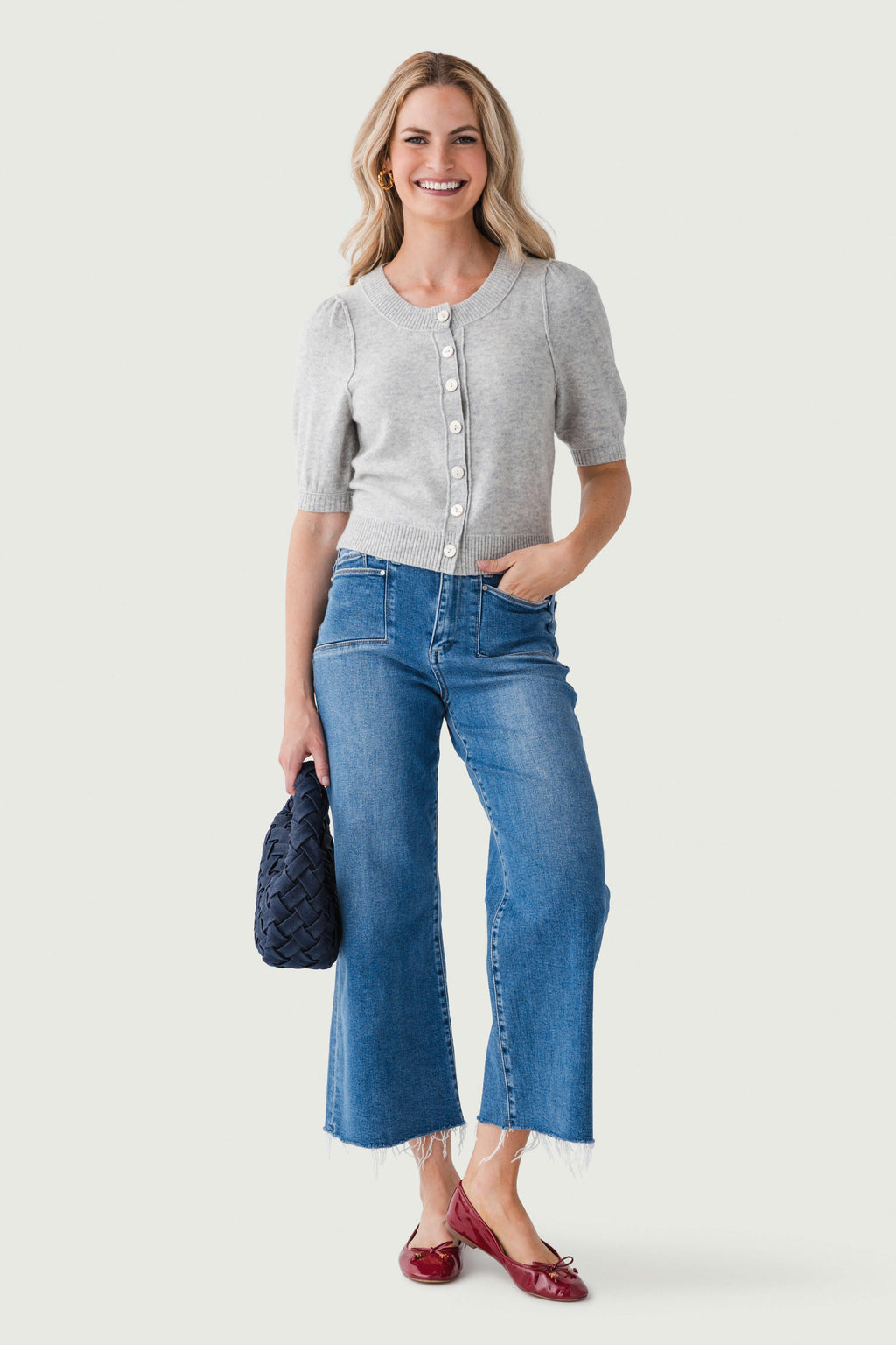 Medium wash ankle flare jeans with mid-rise waist and button front closure