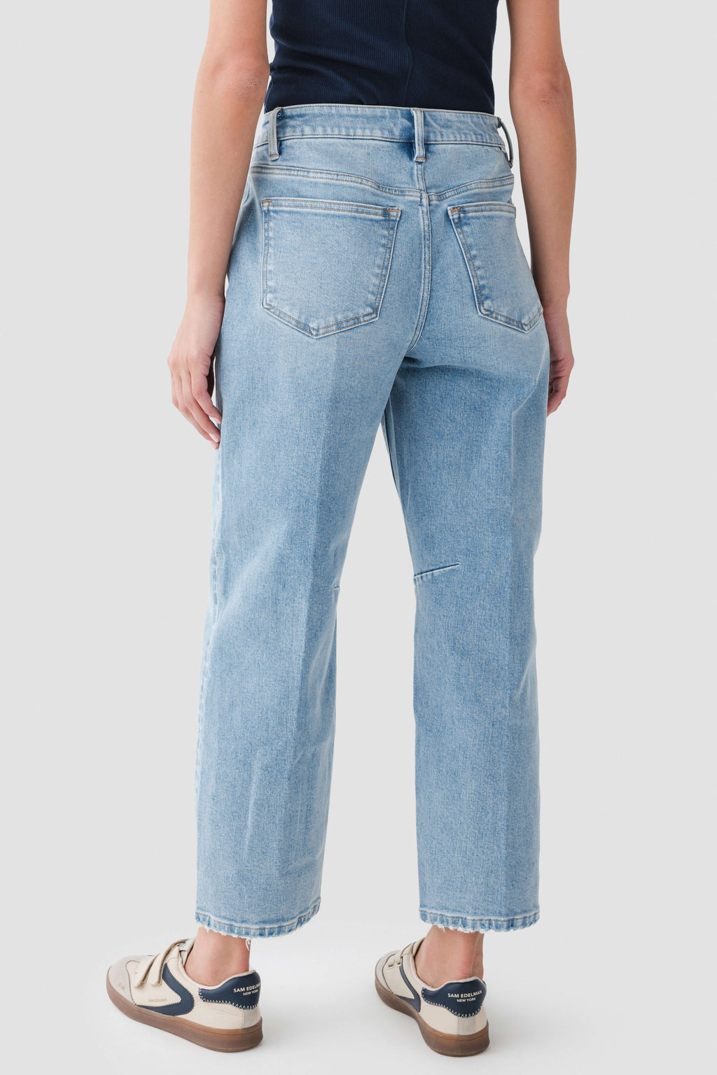 Medium wash barrel jeans front view with belt loops and two front pockets.