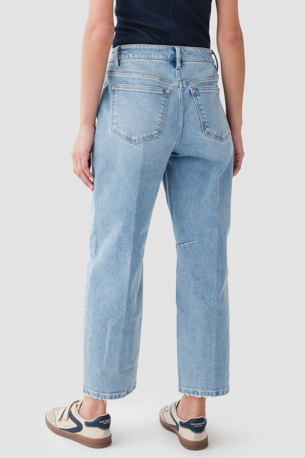 Medium wash barrel jeans front view with belt loops and two front pockets.