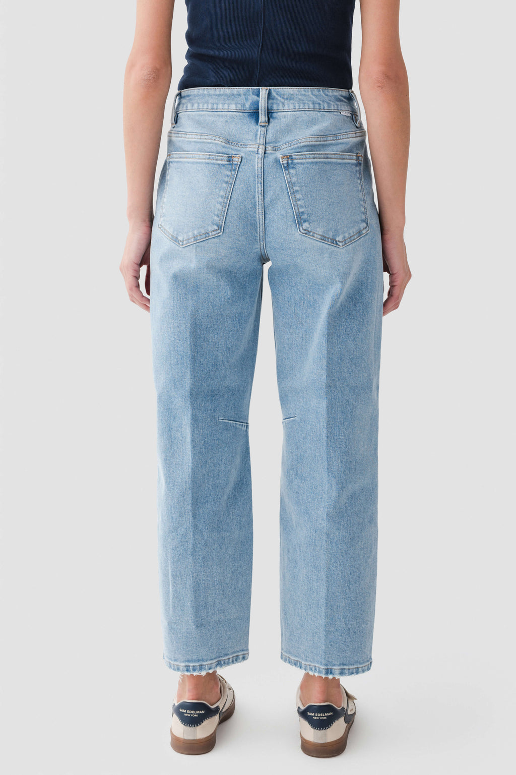 Medium wash denim barrel jeans, rear view with back yoke and stitched pockets.