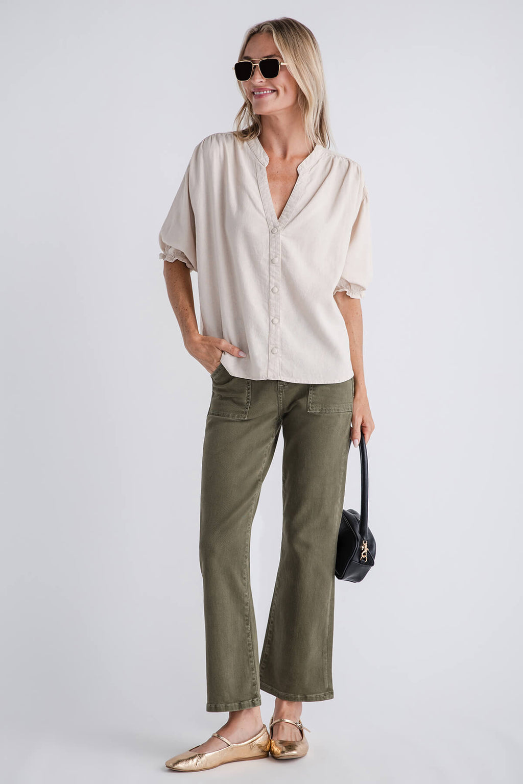 Olive green ankle flare jeans with belt loops, button fly, and wide straight legs
