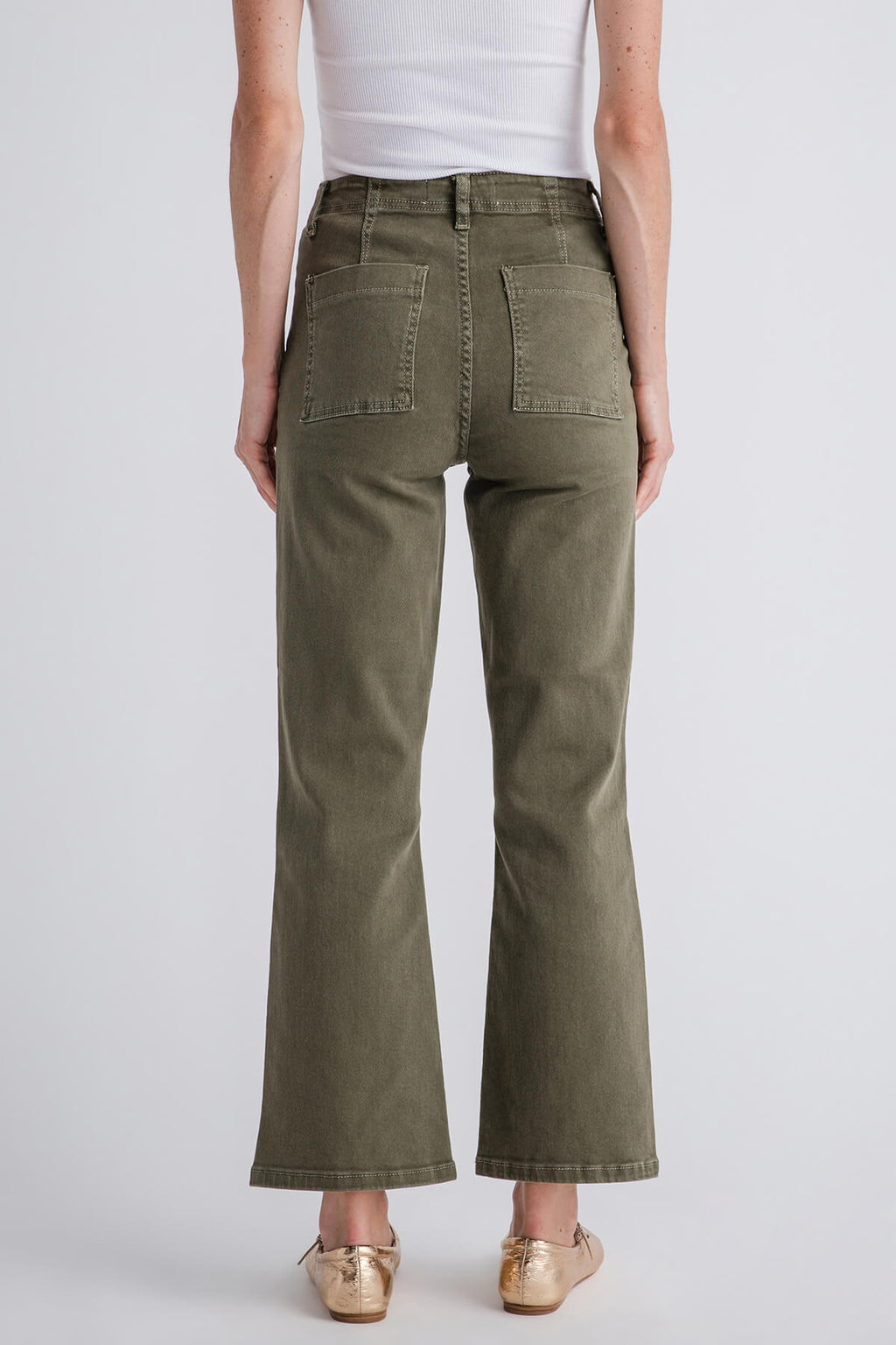 Back view olive green ankle flare jeans with patch pockets and vent at the hem