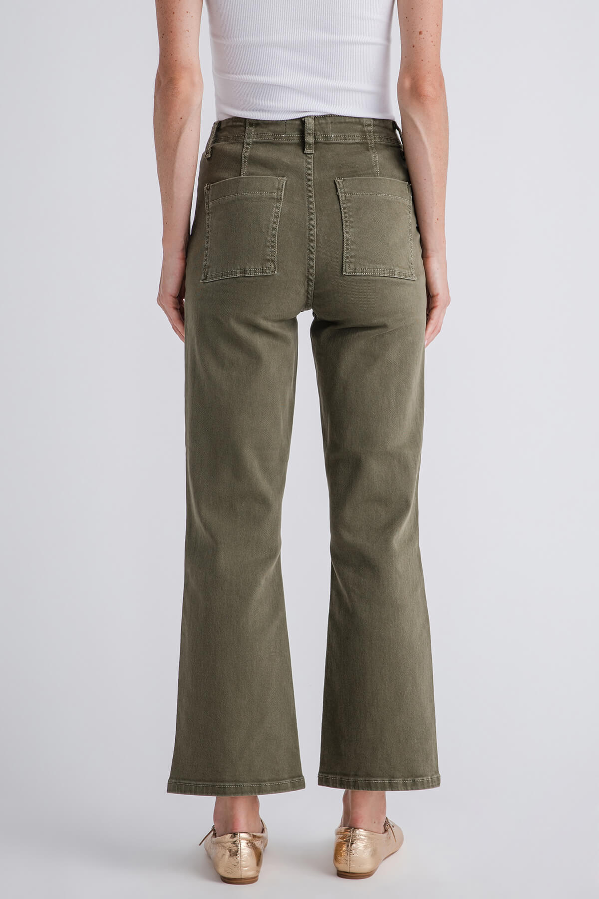 Back view olive green ankle flare jeans with patch pockets and vent at the hem