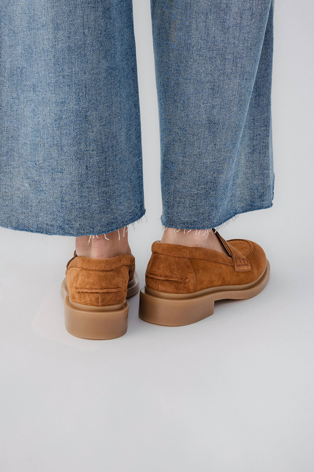 Back view of tan suede loafer with heel tab and rubber outsole