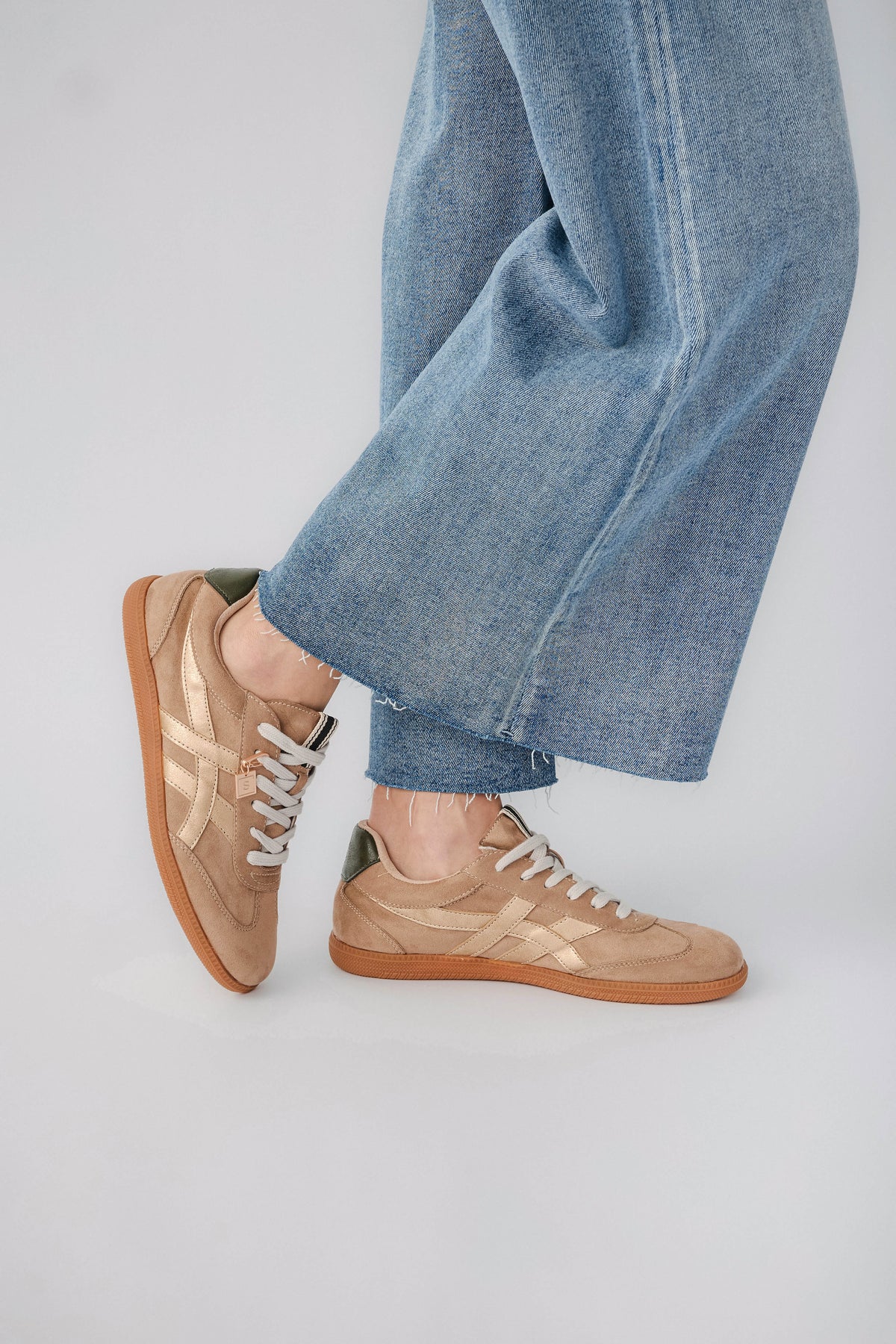 Mink suede low-top sneaker, side view with white laces and gum outsole