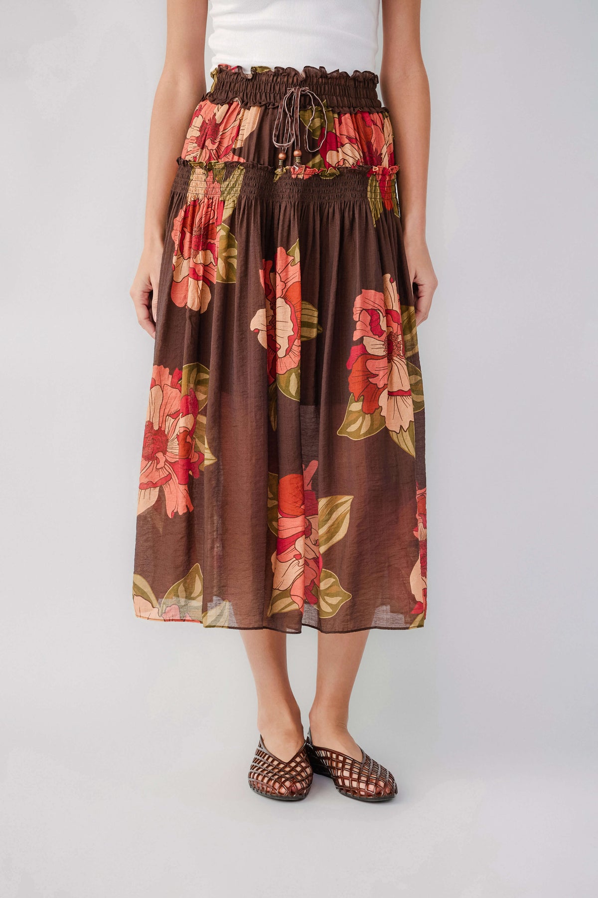 Brown floral print maxi skirt with elastic waistband and pleated tiers