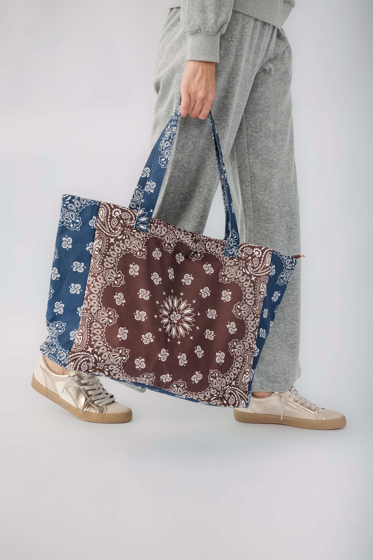 Brown and navy bandana print tote bag with long blue-trimmed handles