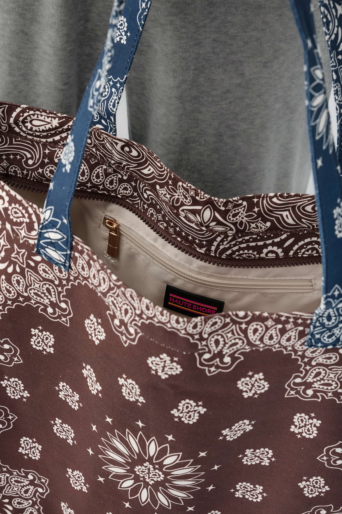 Bandana print tote bag with front zip pocket and brown-and-navy paisley pattern