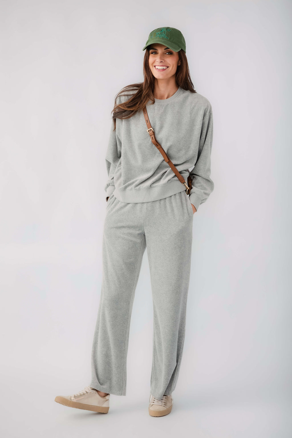Green baseball cap on a model wearing a gray outfit