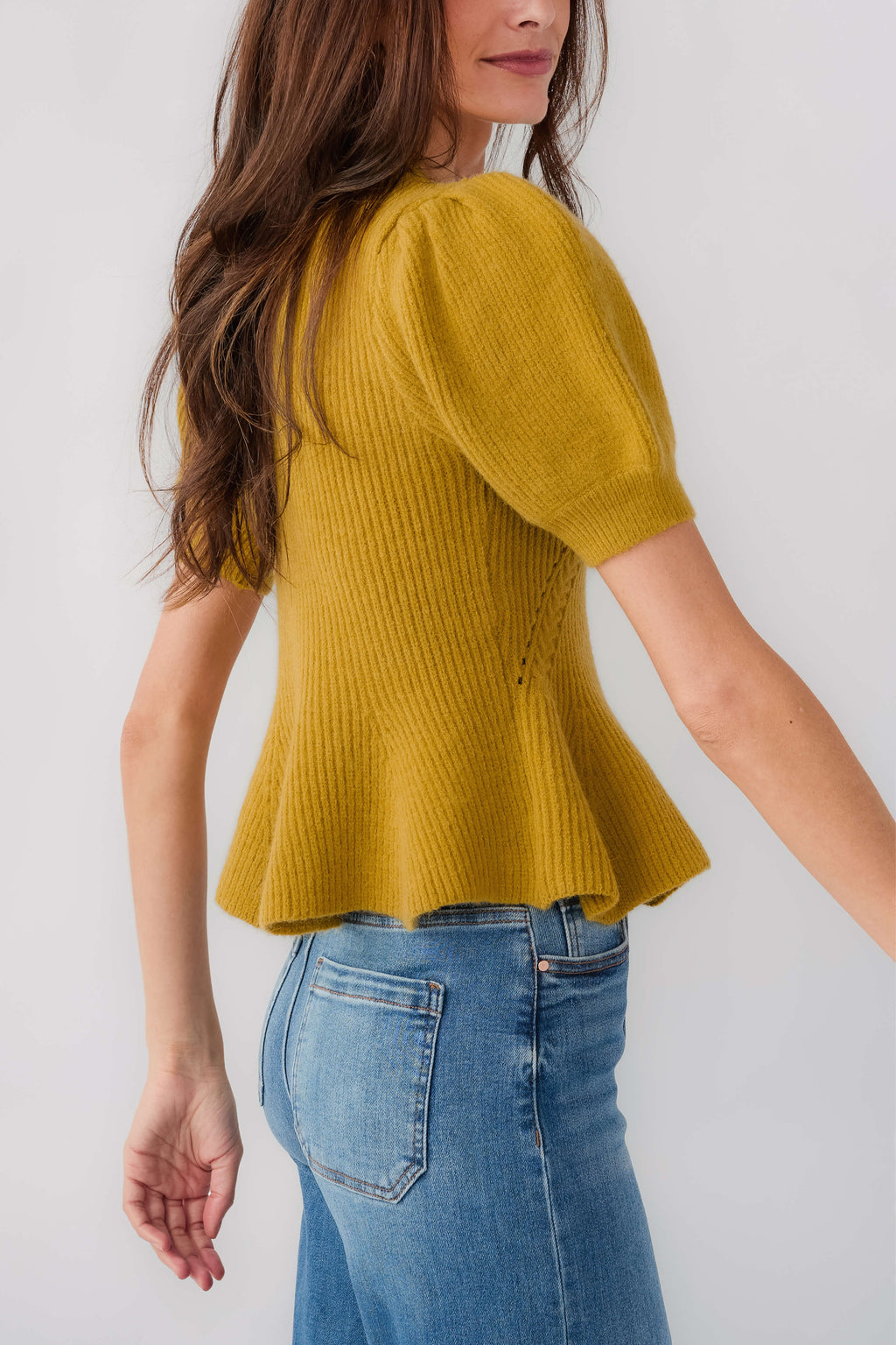 Chartreuse knit top with puff sleeves and textured knit pattern, flared hem