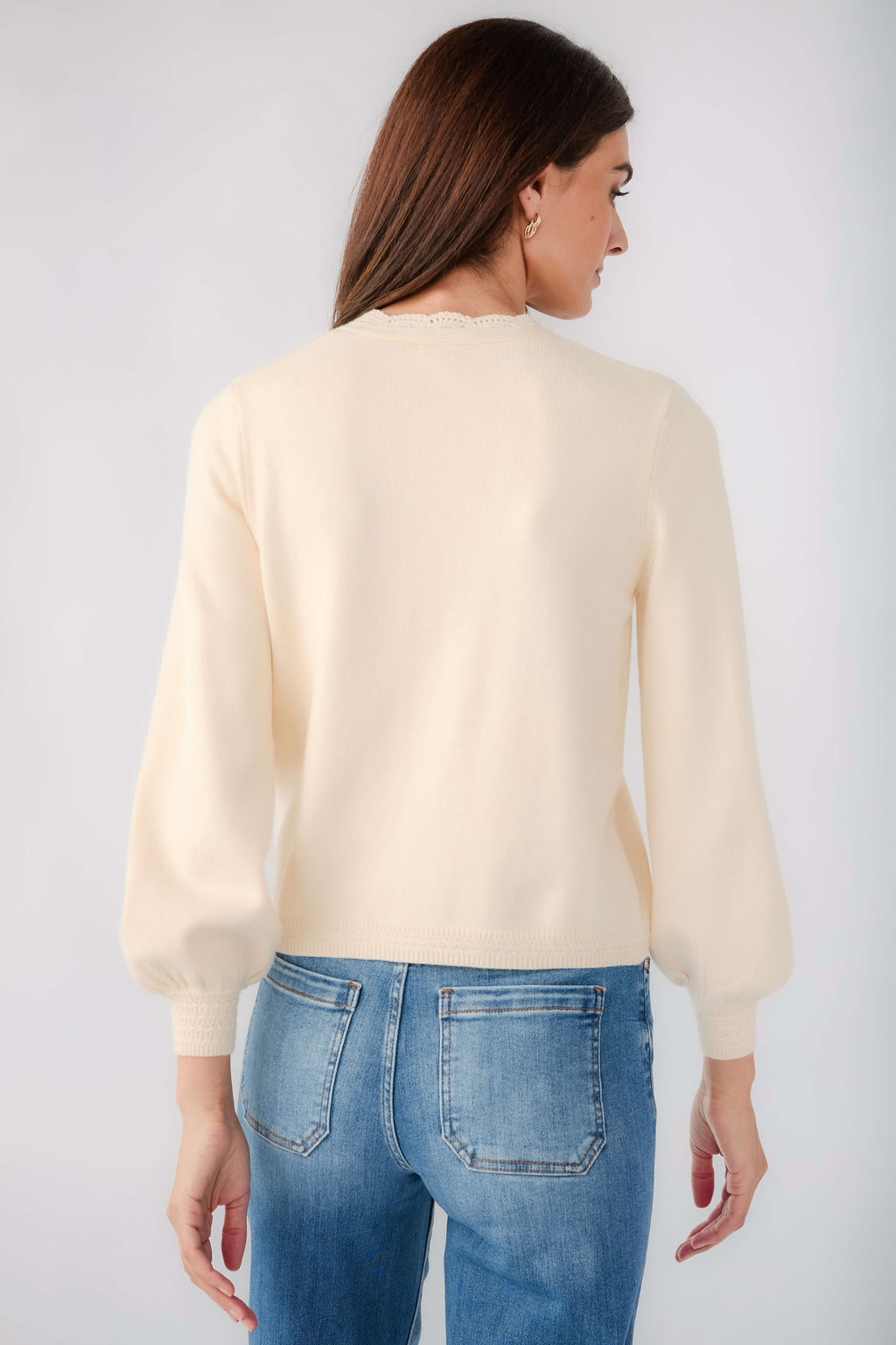 Cream cardigan back view with long sleeves and ribbed cuffs