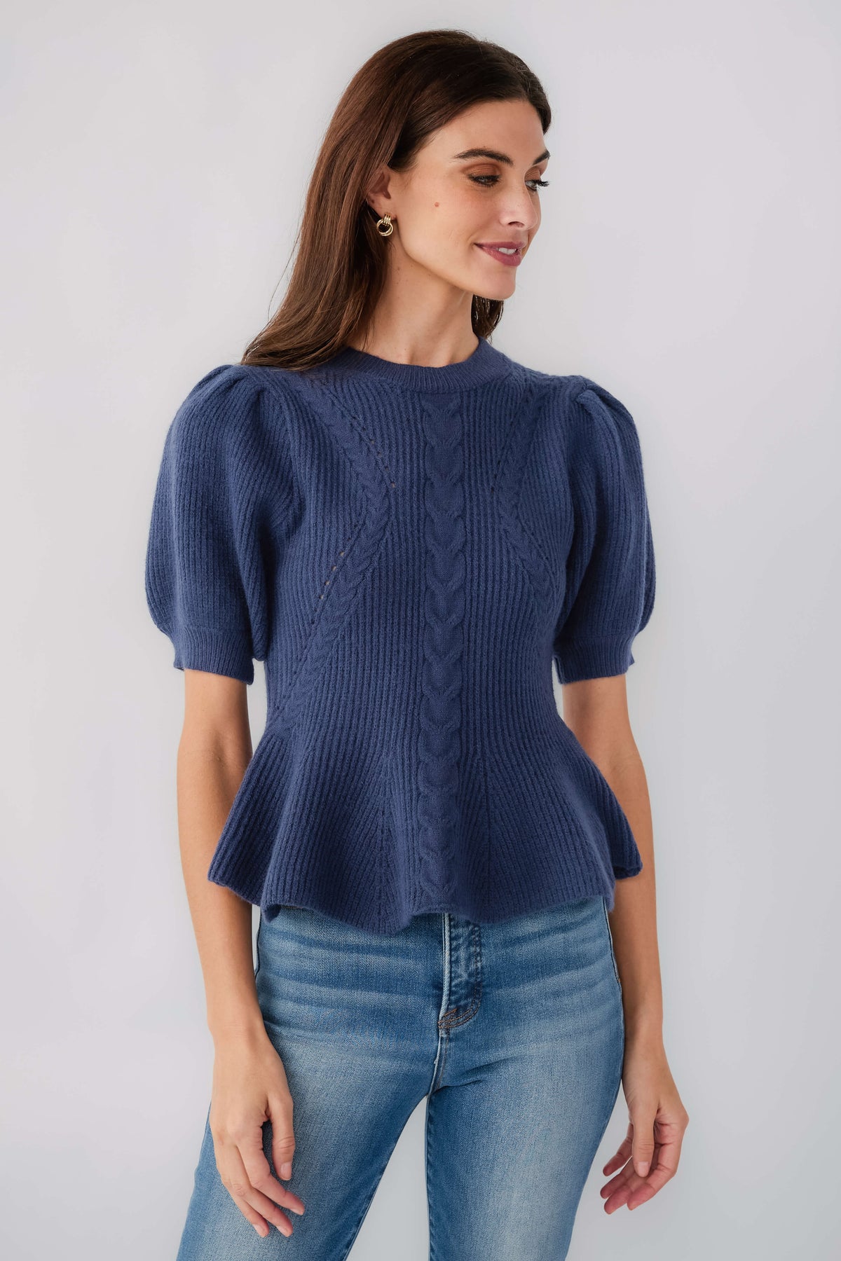 Navy ribbed knit top with puff sleeves, crew neck, and flared hem