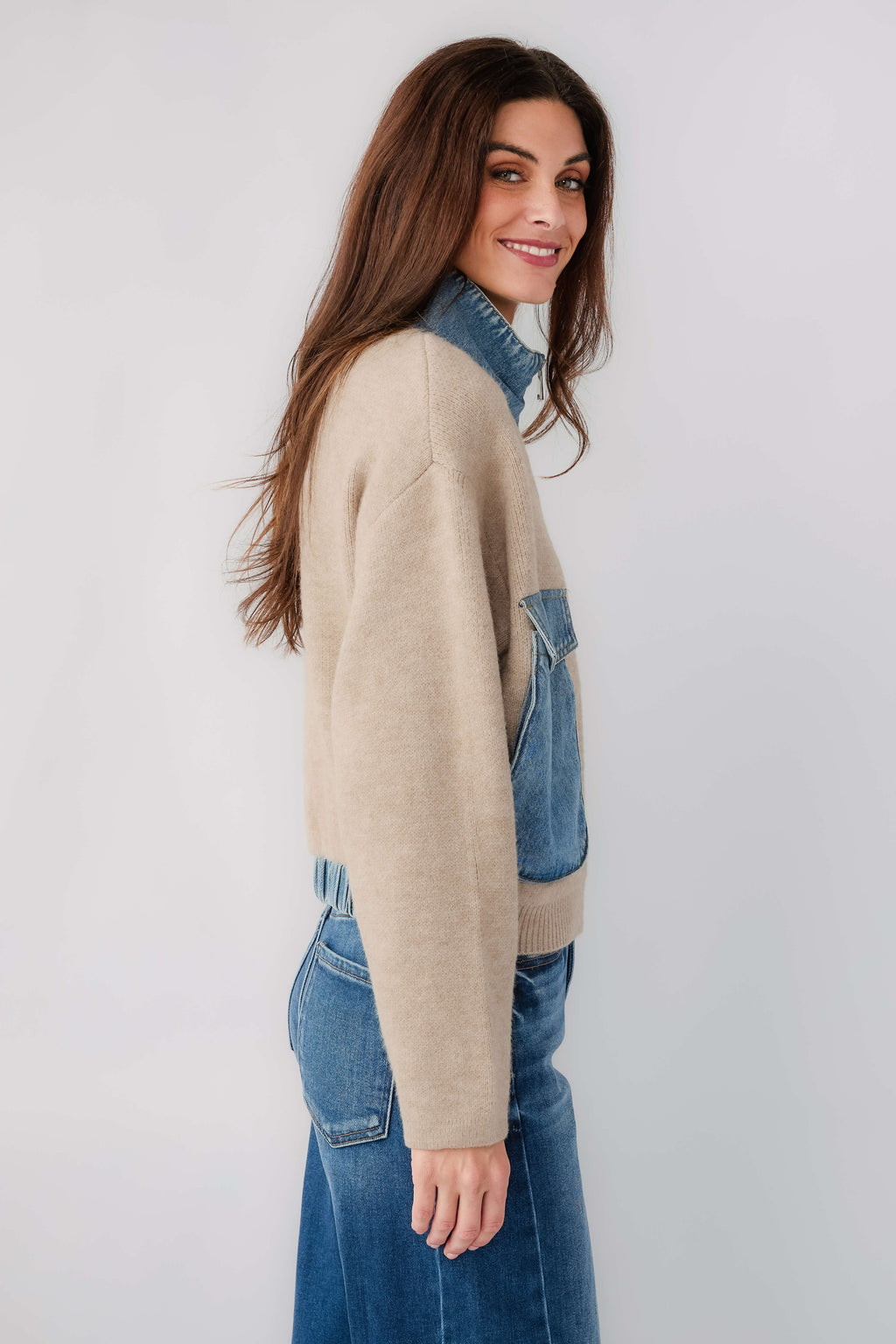 Tan sweater bomber jacket with blue patch pocket and contrast collar, side profile