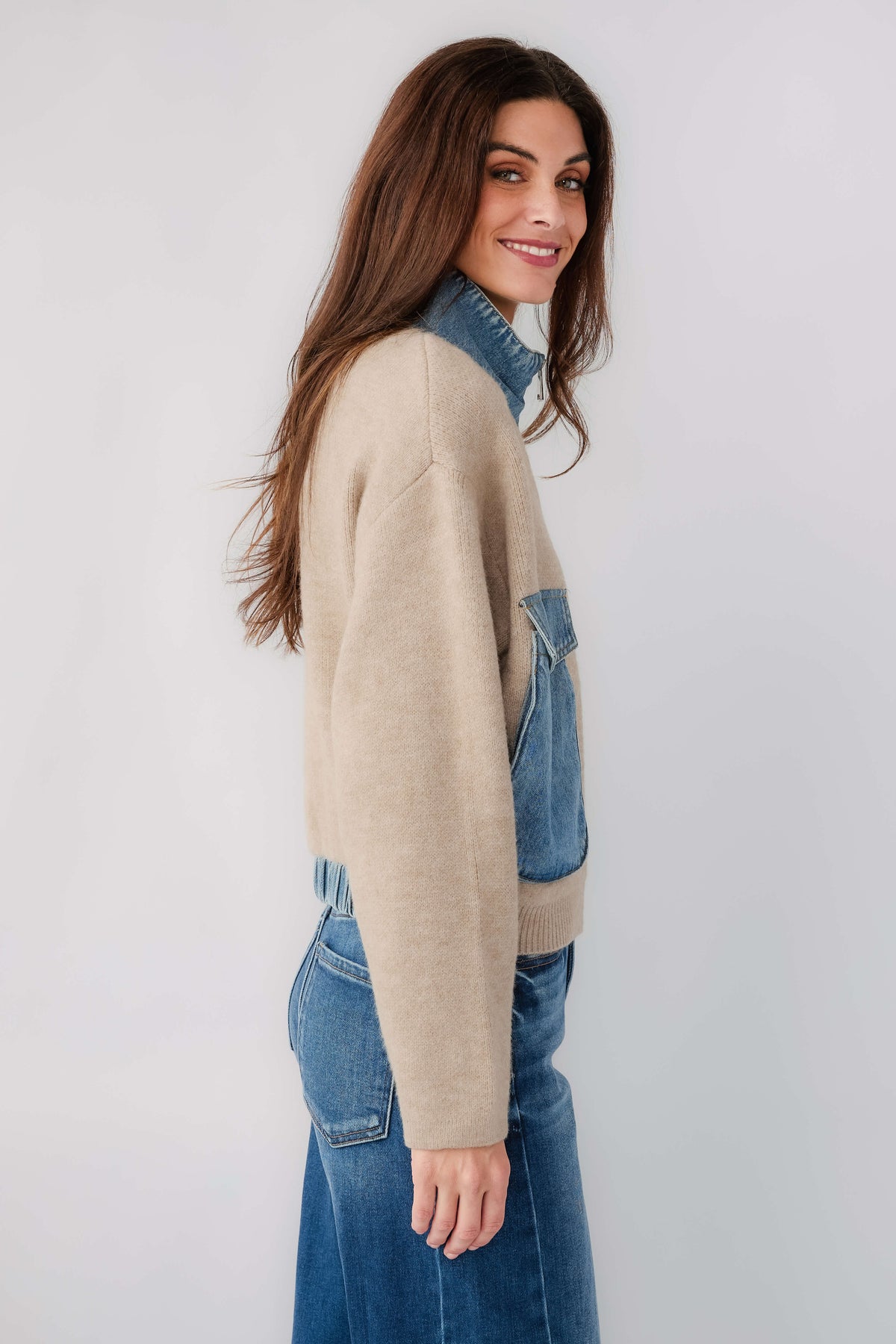 Tan sweater bomber jacket with blue patch pocket and contrast collar, side profile