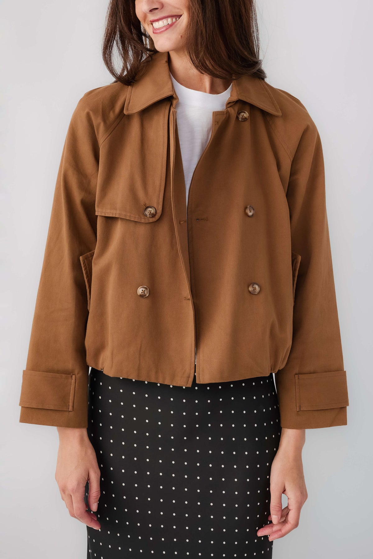 Brown cropped trench jacket with point collar, double-breasted buttons, flap pockets