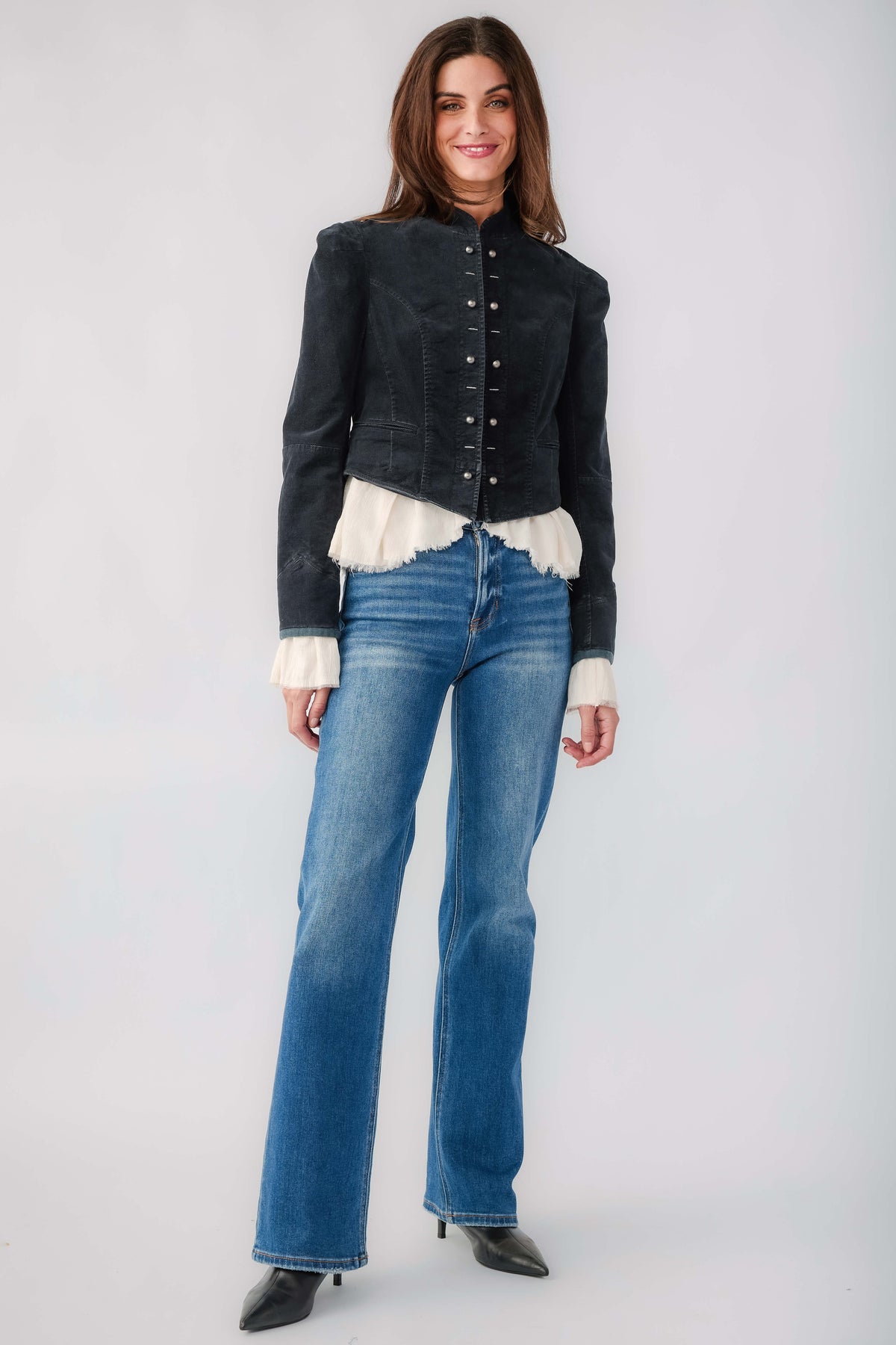 Black denim blazer with button closure, white ruffle hem, worn with blue jeans
