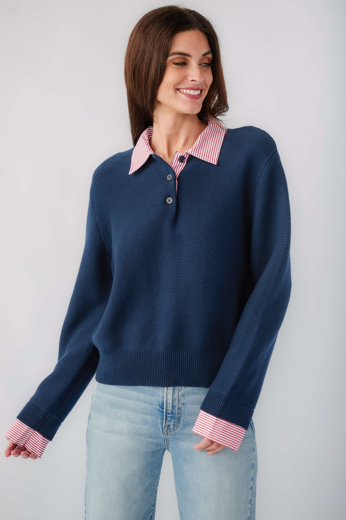 Navy knit sweater with striped pink-red collar and cuffs, long sleeves