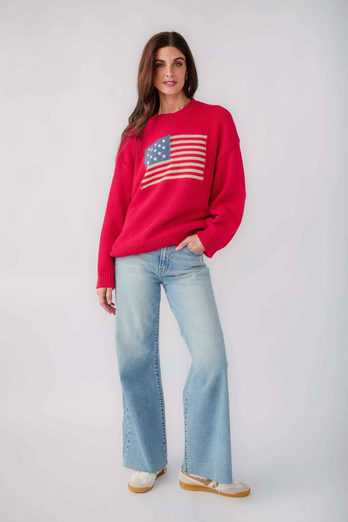 Red crewneck sweater with American flag graphic on the chest and ribbed hem