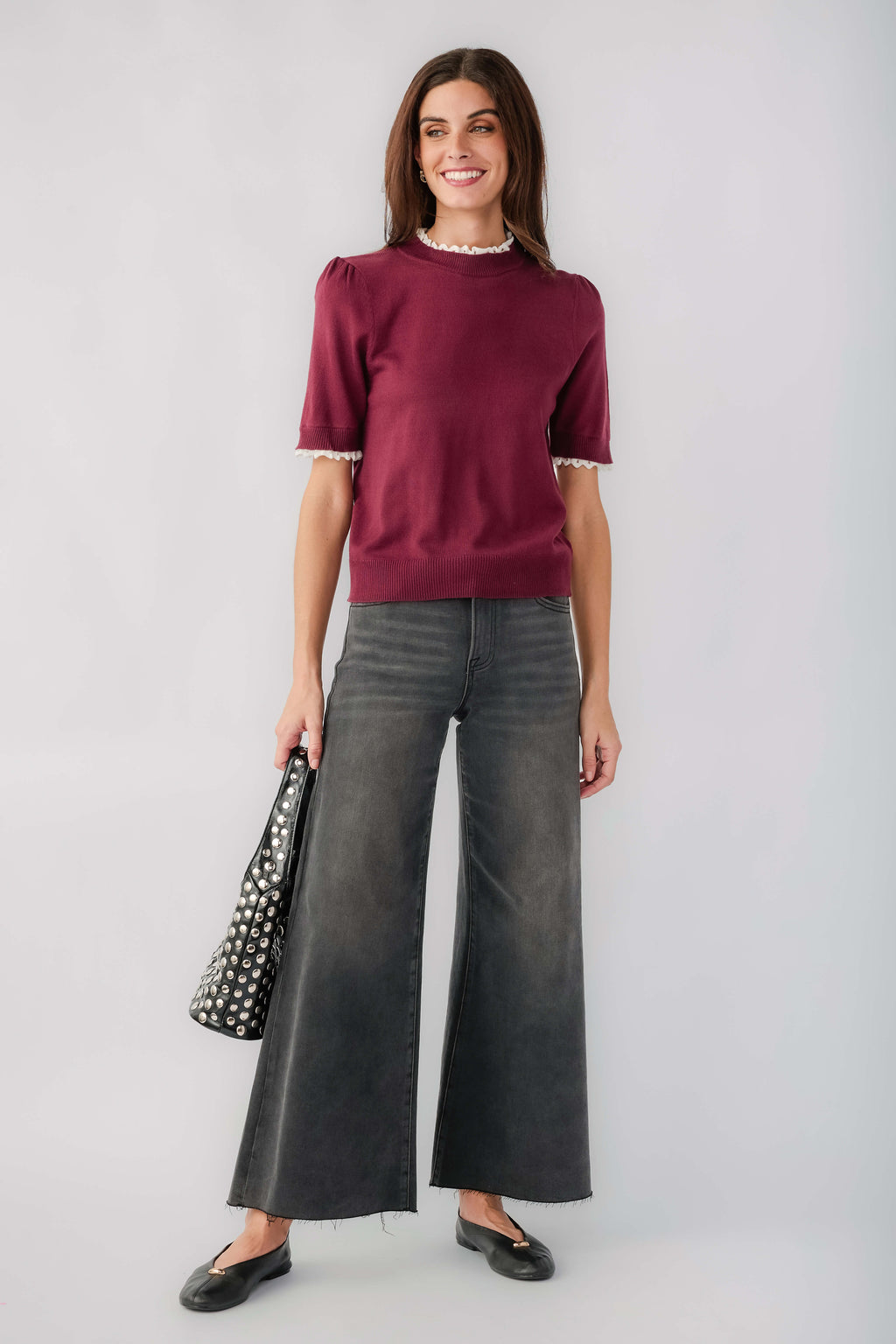 Washed black wide-leg denim jeans with raw hem and front slant pockets