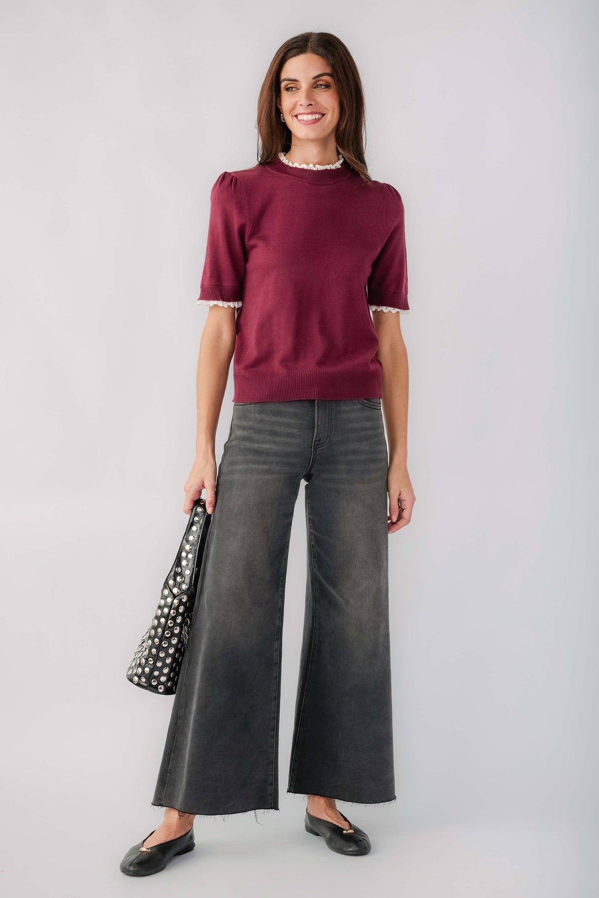 Washed black wide-leg denim jeans with raw hem and front slant pockets